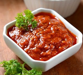 A green cup of a coffee on a wooden table